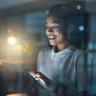 Professional using tablet in modern office environment with ambient lighting